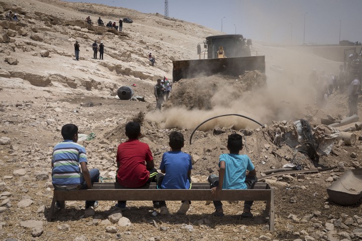 ילדים מול בולדוזר בח'אן אל אחמר. עכשיו המדינה מצפה שהם ישכנעו את שכניהם הבודאים מעבר לכביש להתפנות (צילום: אורן זיו / אקטיבסטילס)