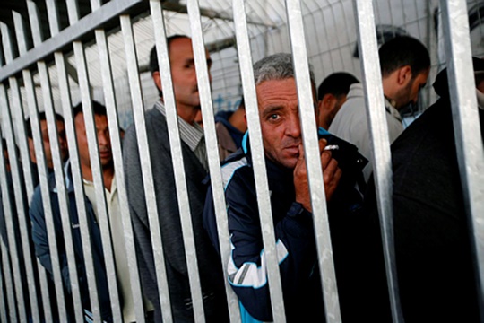קל ללעוג לסבל שלהם. גבר פלסטיני מבוגר ממתין לאישור כניסה (מרים אלסטר/ פלאש90)