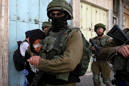 חיילים מובילים עצור פלסטיני בחברון. התמונות האלה כבר נצרבו בתודעה העולמית (צילום: ויסאם השלמון/פלאש90)